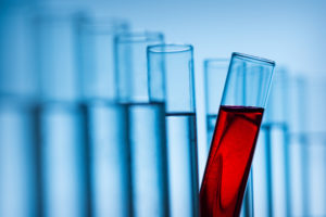 test tubes filled with blue and red liquid