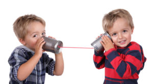 Little boy playing with can phone connected by string, concept for talking to yourself