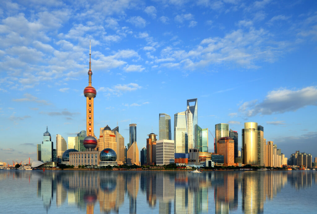 Photo of modern buildings by river at dusk